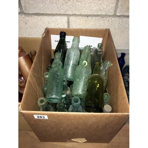 283 - A box of vintage glass bottles including cod bottles