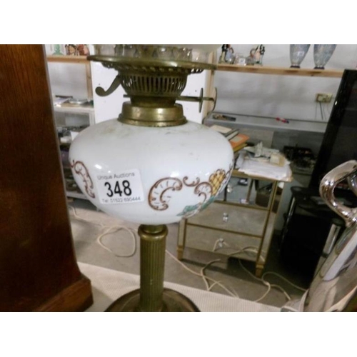 348 - An oil lamp with brass column, pot base, opaque glass font and acid etched shade