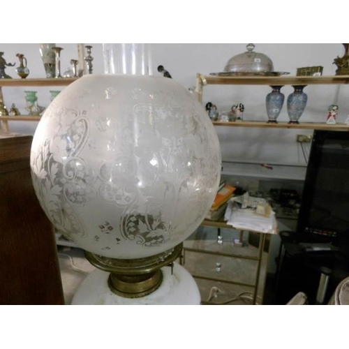 348 - An oil lamp with brass column, pot base, opaque glass font and acid etched shade