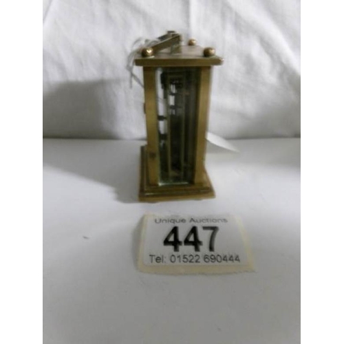 447 - A miniature brass carriage clock in working order