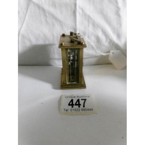 447 - A miniature brass carriage clock in working order