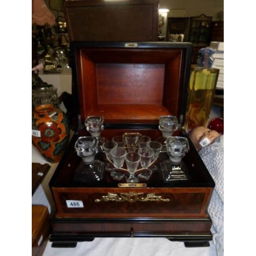 486 - A cased drinks set comprising 4 decanters and 8 glasses in a walnut case