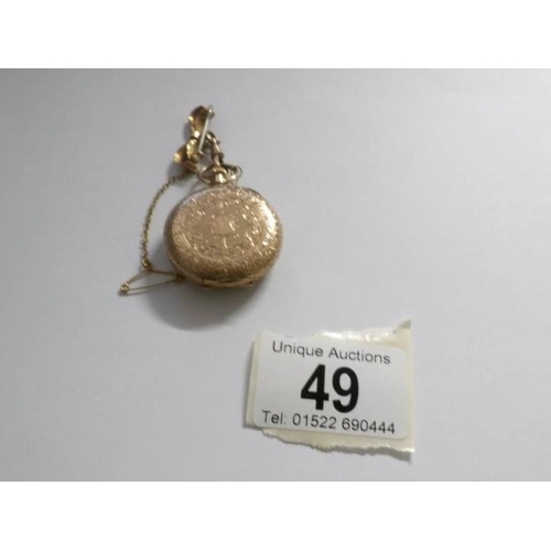 49 - An early 19th century 14ct gold ladies fob watch in chased gold with enamel face and surmounted by r... 