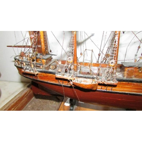 713 - A cased antique model of a tall ship in glass case (missing front glass)