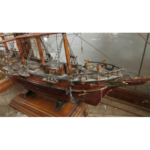 713 - A cased antique model of a tall ship in glass case (missing front glass)