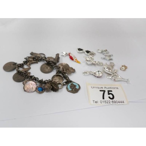 75 - An early 20th century charm bracelet together with later loose charms including some silver