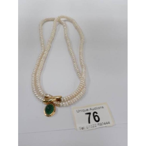 76 - An 18ct gold and pearl necklace set with green gemstone and diamond clasp