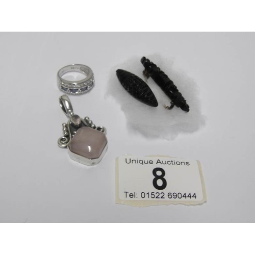 8 - A silver and rose quartz pendant, a silver ring, a Whitby? jet brooch and one other brooch