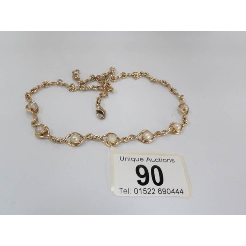 90 - A gold necklace set with seven split pearls in a twisted link style, total weight approximately 20.2... 