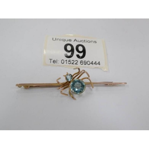 99 - A 9ct gold spider brooch with aquamarine stones