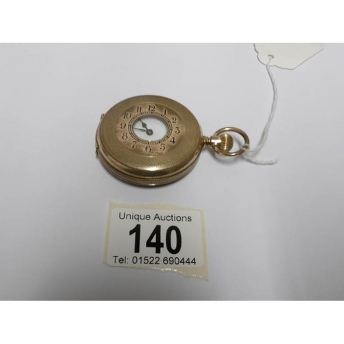 140 - A gold filled half hunter pocket watch with enamel dial (missing glass)