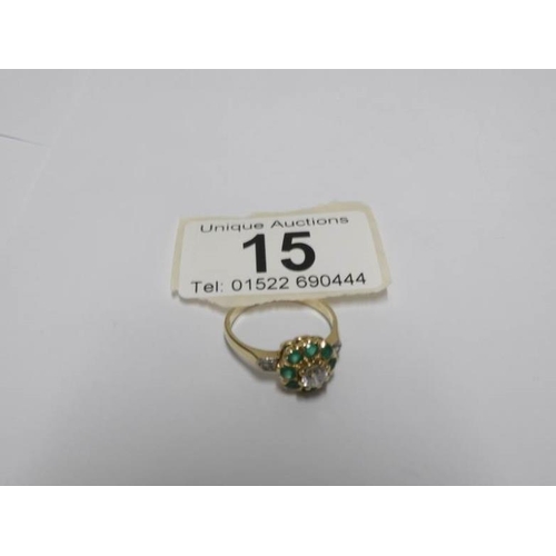 15 - An 18ct yellow gold diamond and emerald ring, size P