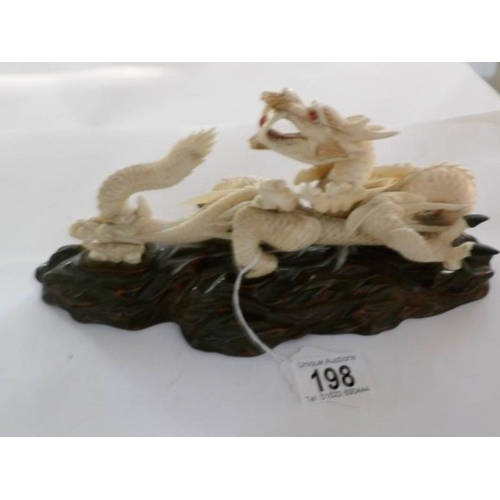 198 - A 19th century carved ivory dragon, signed