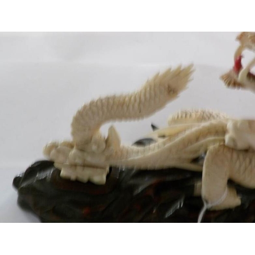 198 - A 19th century carved ivory dragon, signed