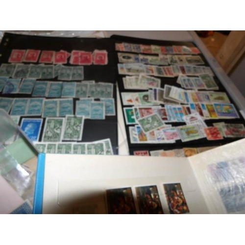 221 - Several sheets of world stamps, a stamp album and a box of stamps