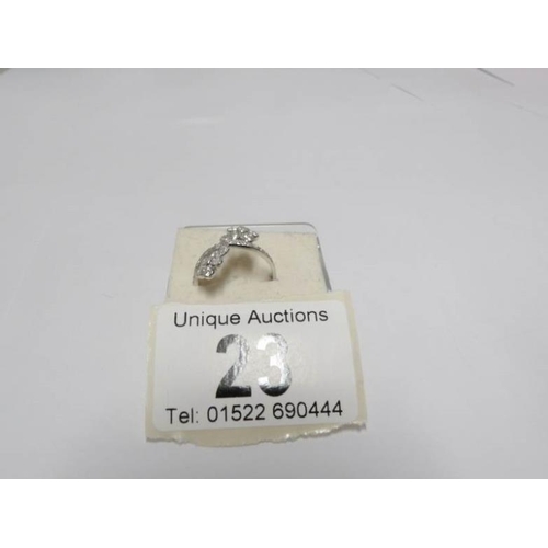 23 - An 18ct white gold 65pt diamond crossover ring, size M