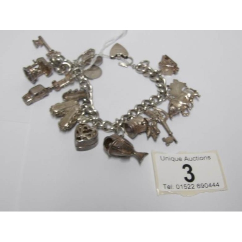 3 - A silver charm bracelet with approximately 14 silver charms