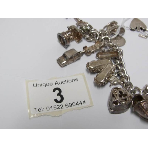 3 - A silver charm bracelet with approximately 14 silver charms