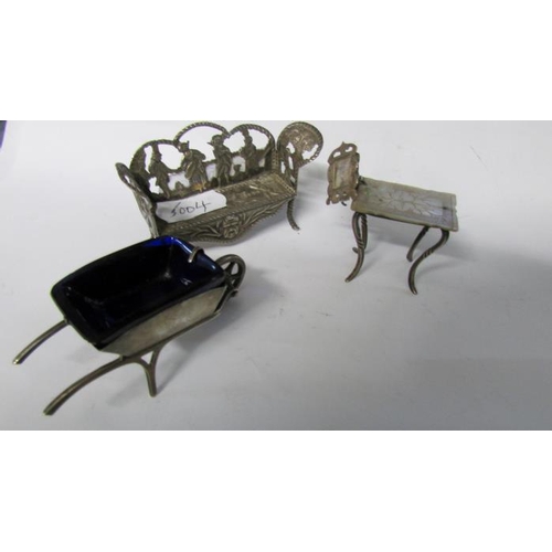 431 - A miniature silver wheelbarrow, miniature silver seat and miniature silver table with photo frame