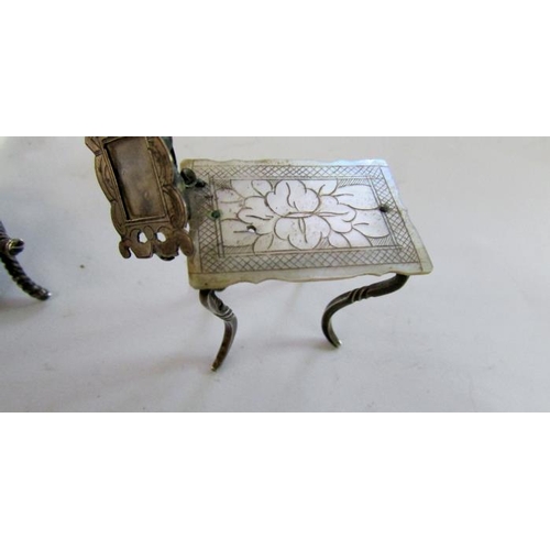 431 - A miniature silver wheelbarrow, miniature silver seat and miniature silver table with photo frame