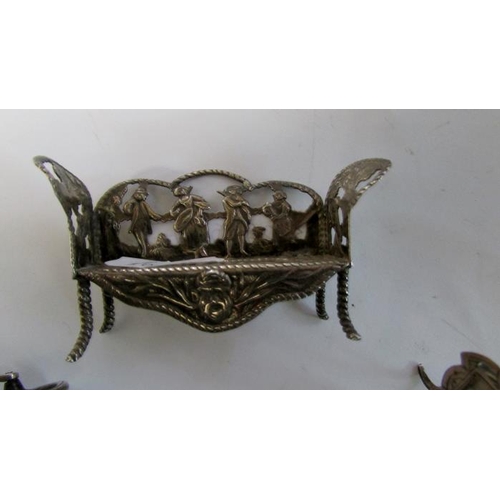 431 - A miniature silver wheelbarrow, miniature silver seat and miniature silver table with photo frame