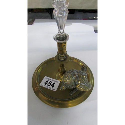 454 - A glass specimen flute on brass base surmounted with bird figure