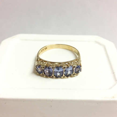 64 - A tanzanite 5 stone ring in gold, size O