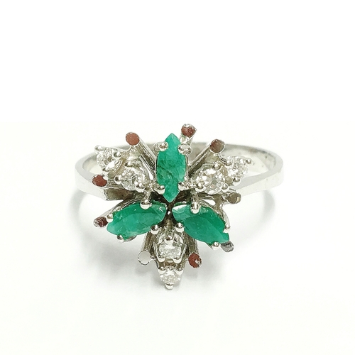 84 - A diamond and emerald ring in 14ct gold fashioned as a flower head, size O