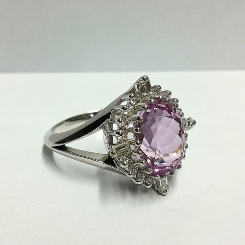 92 - A Kunzite gem set ring with brilliant and baguette diamonds to surround in 18ct white gold