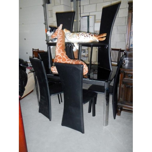 21 - A black smoked glass dining table & 6 chairs