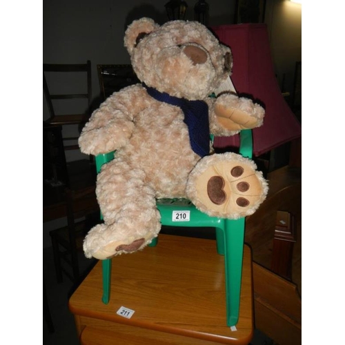 210 - A Teddy bear & green plastic chair