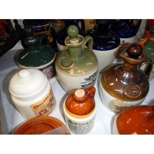 264 - A collection of earthenware jars including whisky & Advertising etc.