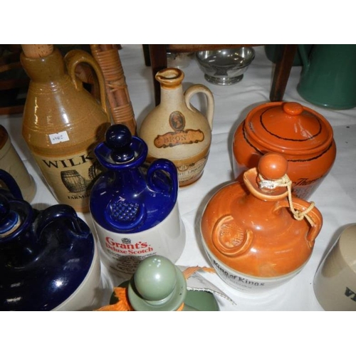 264 - A collection of earthenware jars including whisky & Advertising etc.