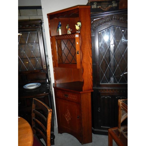 28 - A corner display cabinet with leaded glass door