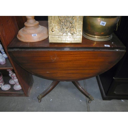 351 - A drop leaf table with claw feet