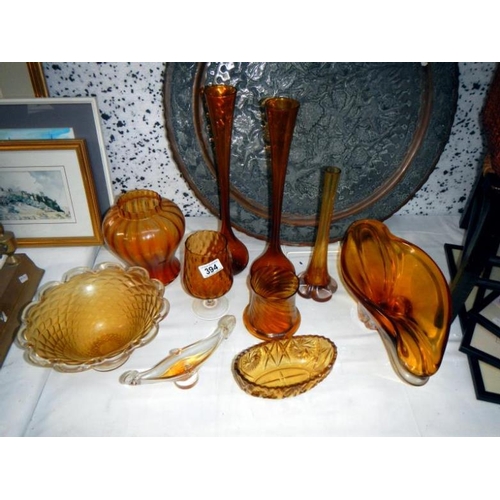 394 - A quantity of amber coloured glass items