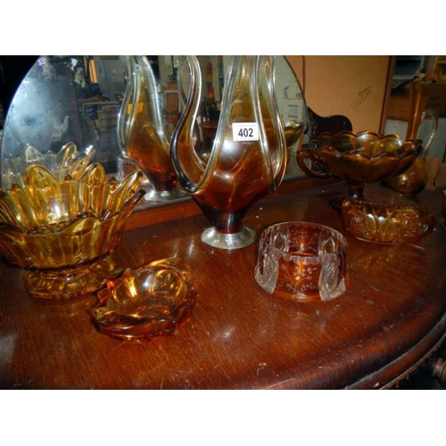 402 - A quantity of amber glass items