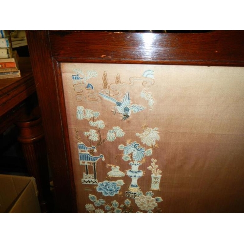 52 - A fire screen with a Chinese silk panel