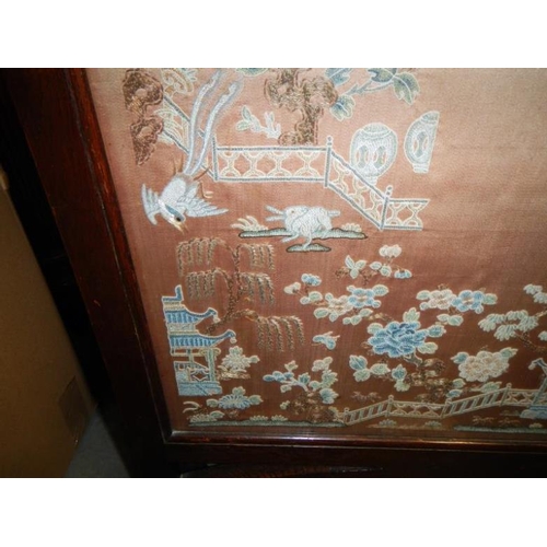 52 - A fire screen with a Chinese silk panel