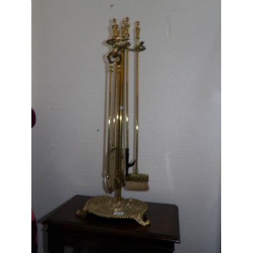 600 - A tall brass companion set