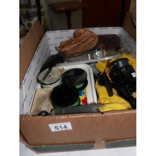 614 - A box of old fishing reels and other fishing items