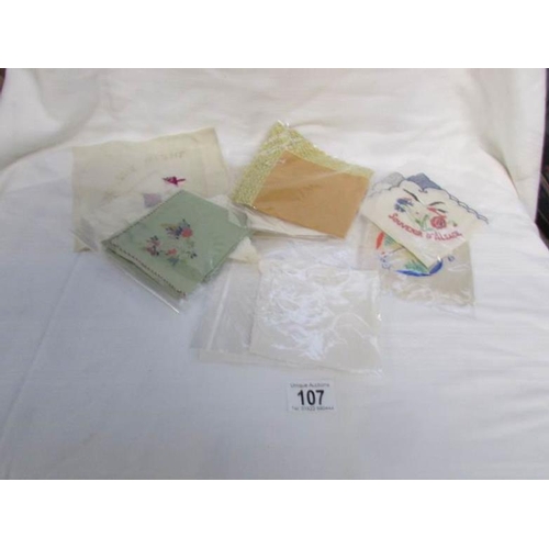 107 - A quantity of vintage handkerchiefs and a WW1 silk card