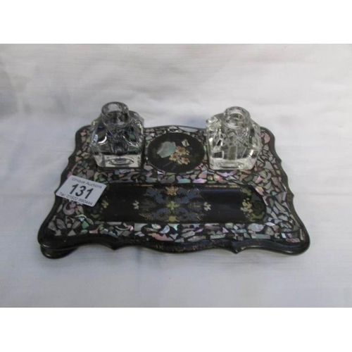 131 - A pretty Victorian papier mache' ink stand decorated with gilt and mother of pearl