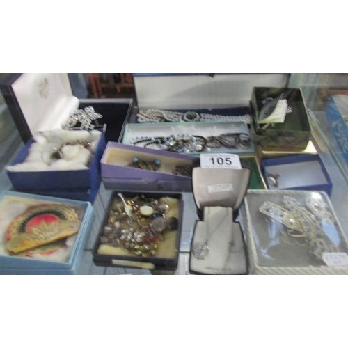 105 - A mixed lot of costume jewellery including brooches, earrings, cuff links etc