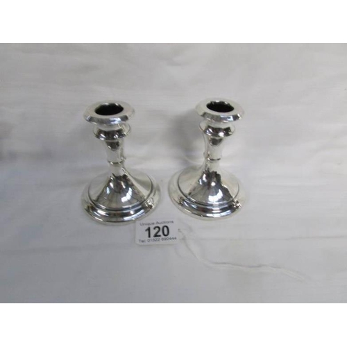 120 - A pair of silver candlesticks