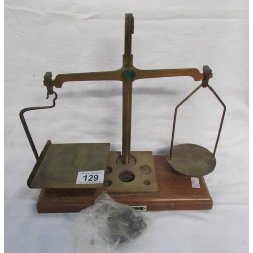 129 - A set of postal scales with weights (one weight missing)