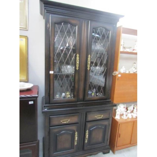 177 - A mahogany effect display cabinet with leaded doors