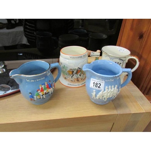 182 - 2 Widdecombe Fair musical mugs (in working order) and 2 jugs by Crown Devon and Widdecombe pottery