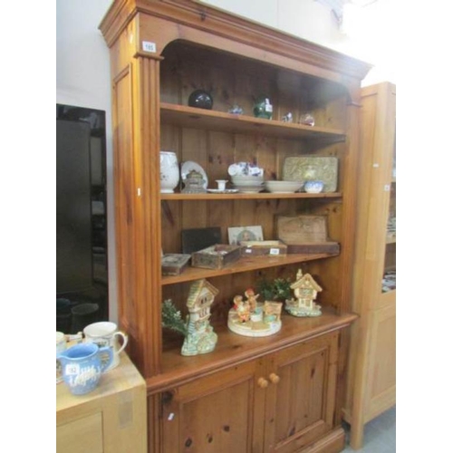 185 - A good quality pine bookcase with cupboard base