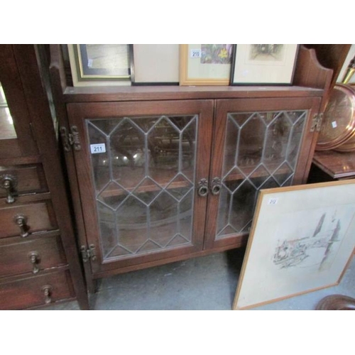 211 - An oak lead glazed wall cabinet